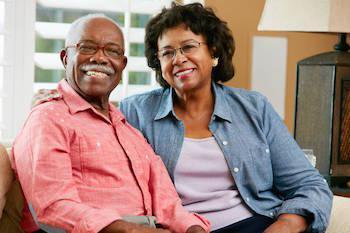 older couple smiling on couch