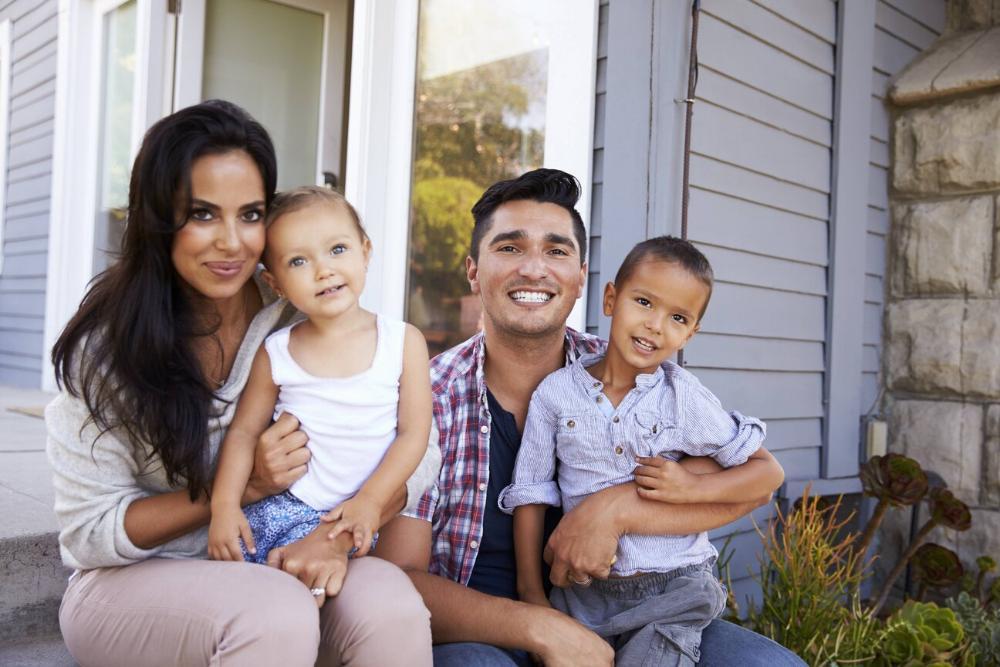 mother, father, and two children smiling