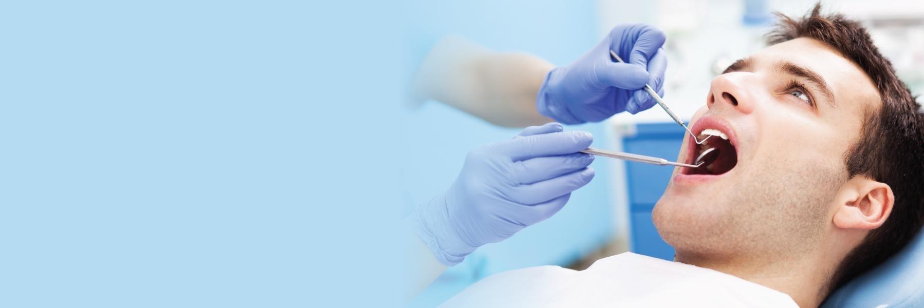 man in dental chair getting dental care