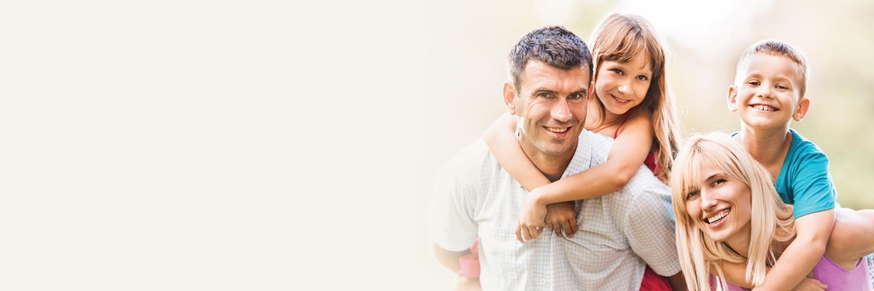 family of four smiling