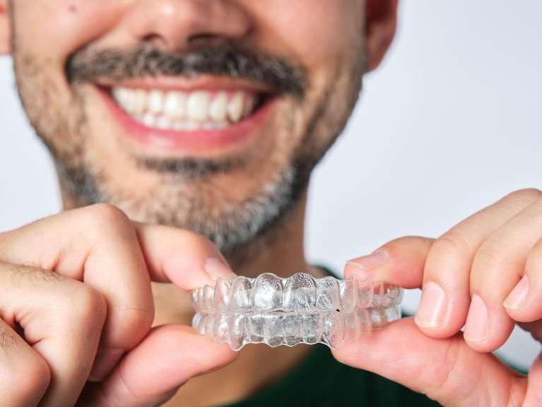 man holding invisalign